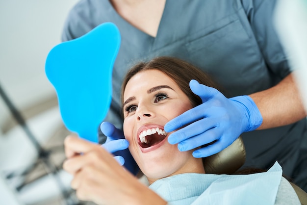 Male dentist and woman in dentist office