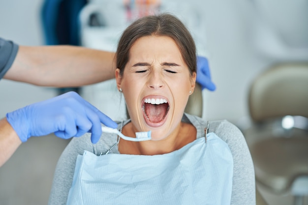 Male dentist and woman in dentist office