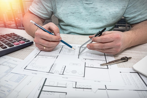 Male designer hands working with color palette on table