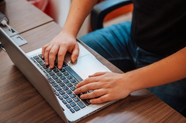 Male designer typing on a keyboard view from above