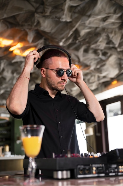 Male dj taking care of the music entertainment at a party