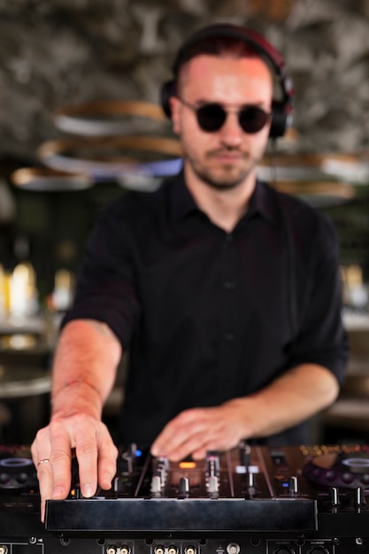 Male dj taking care of the music entertainment at a party