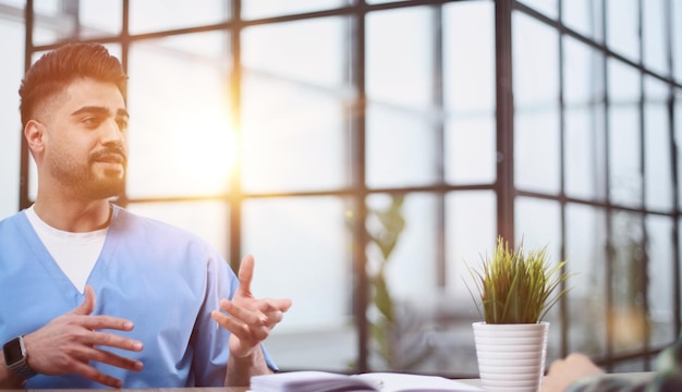 male doctor consulting patient filling form at consultation