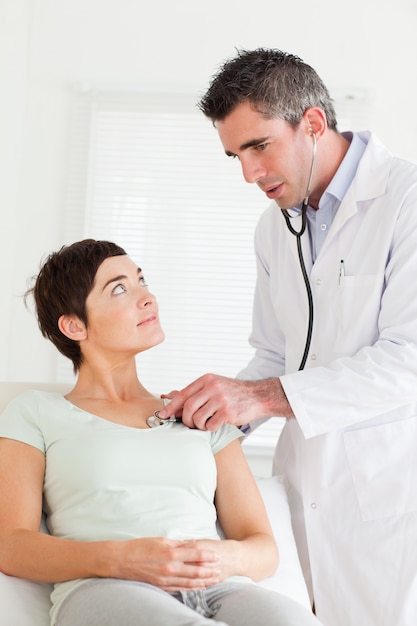 Male Doctor examining a female patient