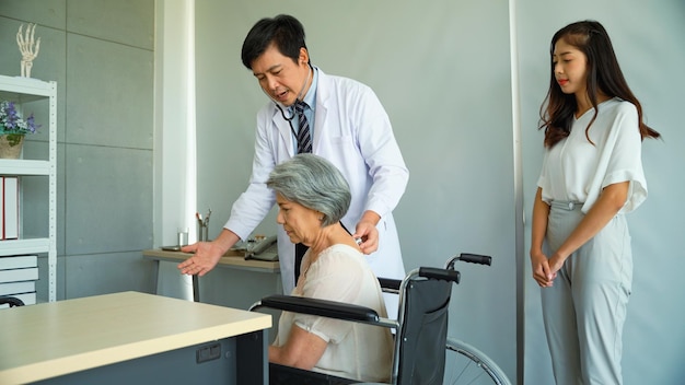 Male doctor explaining the cause of his illness for elderly female patients in wheelchairs