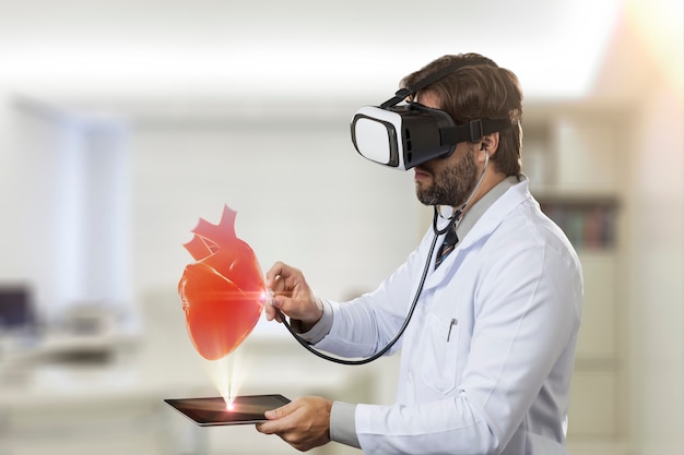 Male doctor in his office,using a Virtual Reality Glasses, looking at a virtual heart