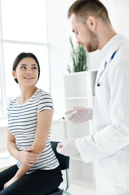 Male doctor holding an injection coronavirus health