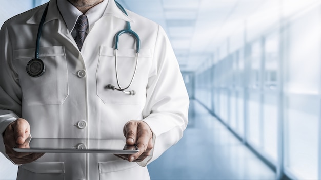 Male Doctor Holding Tablet Computer