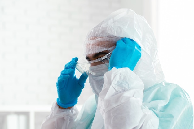 Male doctor in protective medical uniform in clinic