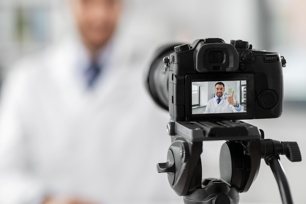 male doctor recording video blog at hospital