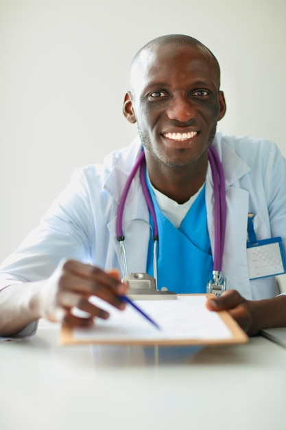 Male doctor sitting at his desk