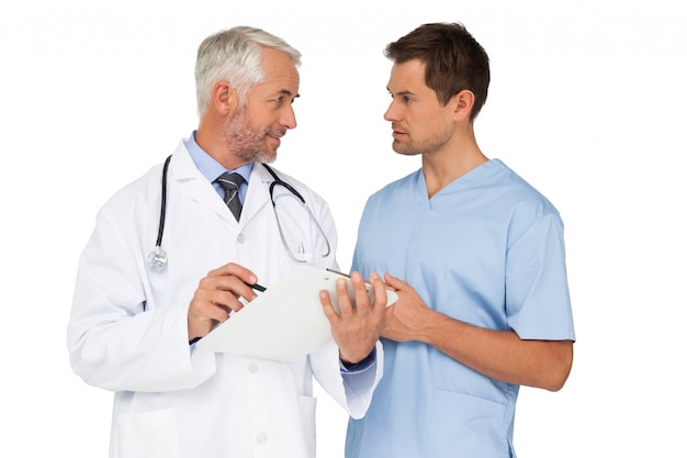 Male doctor and surgeon discussing reports