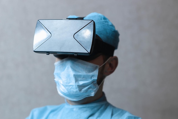 male doctor surgeon in uniform and VR glasses helmet the use of virtual reality in medicine Modern