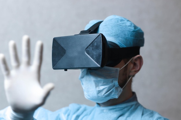 male doctor surgeon in uniform and VR glasses helmet the use of virtual reality in medicine Modern