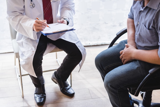 Male doctor and testicular cancer patient are discussing about testicular cancer test report. Testicular cancer and prostate cancer concept.