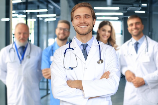 Male doctor with group of happy successful colleagues