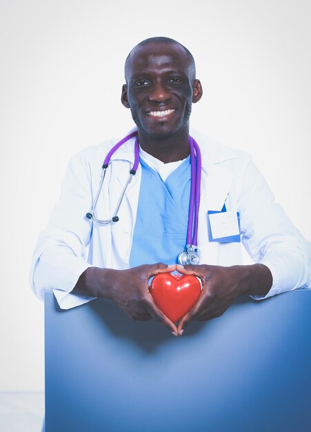 Male doctor with red heart and blank sign isolated on white background Doctor White background