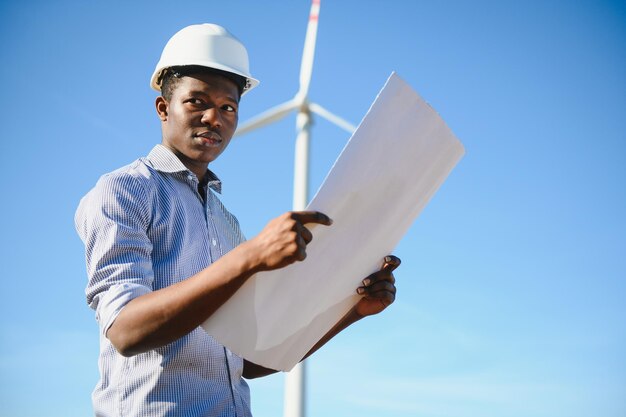 Male engineer on windmill farm for electric power production