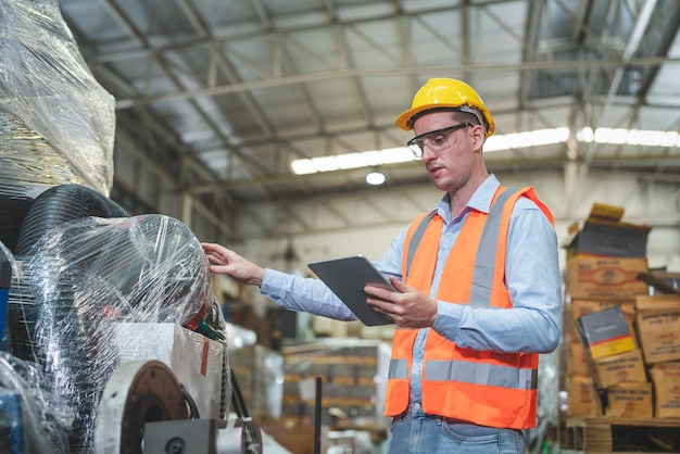 Male engineer with tablet checking product for prepare send to customer in stock at warehouse