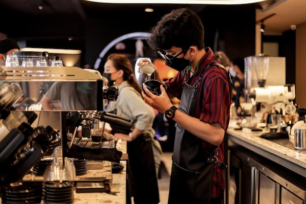 Male and female barista are busy making a coffee at coffee shop