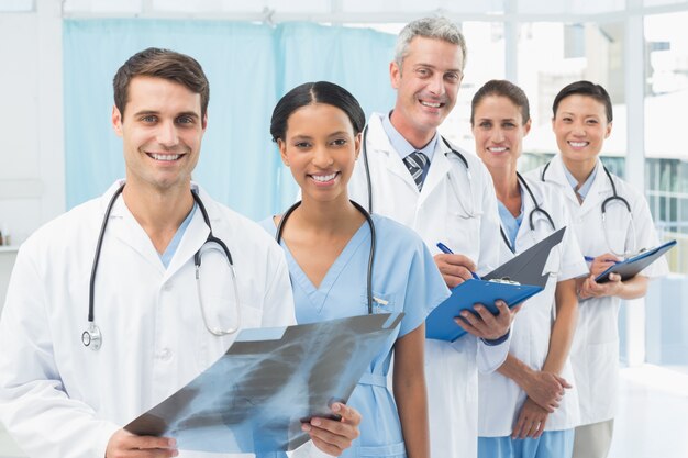 Male and female doctors examining x-ray