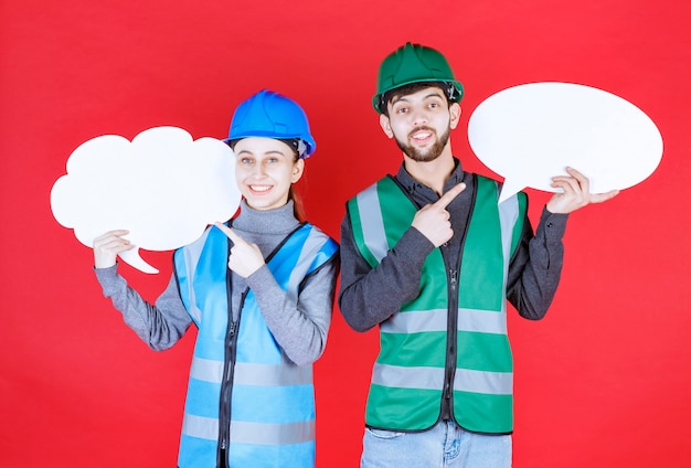 Male and female engineers with helmet holding a cloud and ovale shape info board.