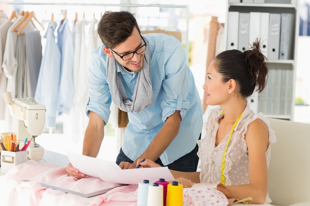 Male and female fashion designers at work in a studio