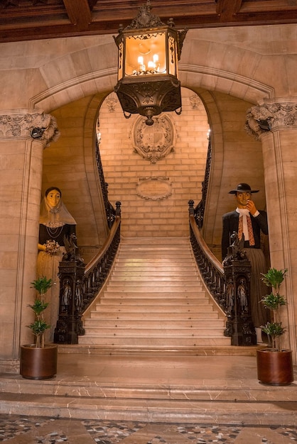 Male and female mannequins at entrance of historic building in old town