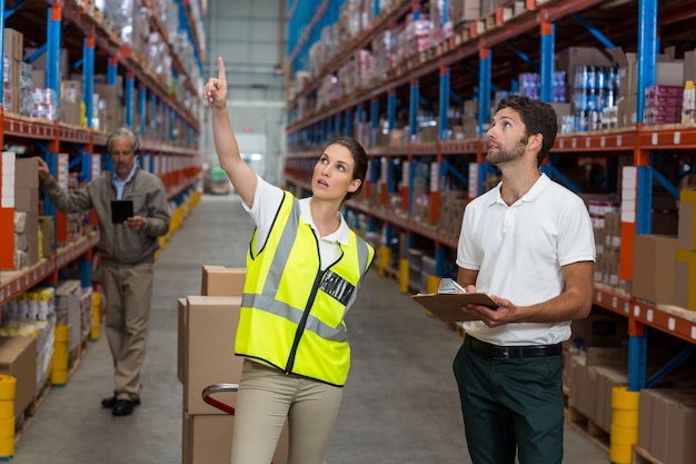 Male and female worker checking inventory