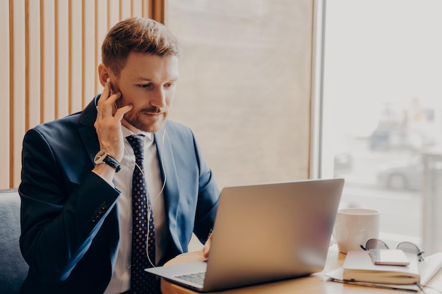 Male finance accountant working online through laptop