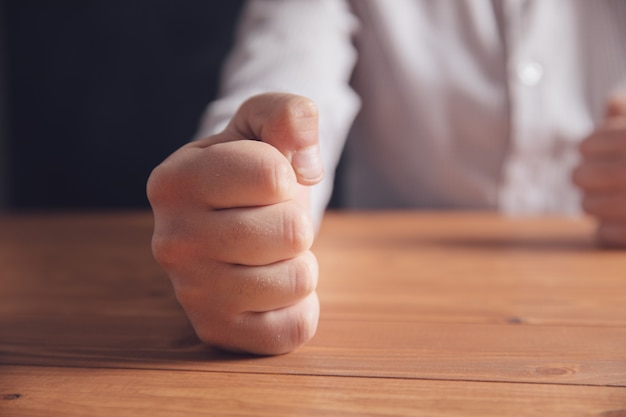 Male fists on the table .