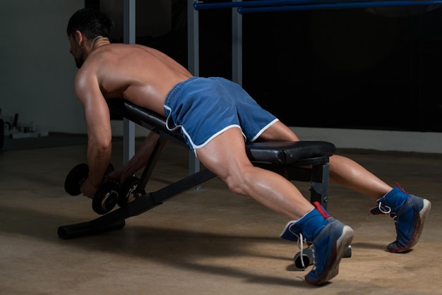 Male Fitness Athlete Doing Heavy Weight Exercise For Back