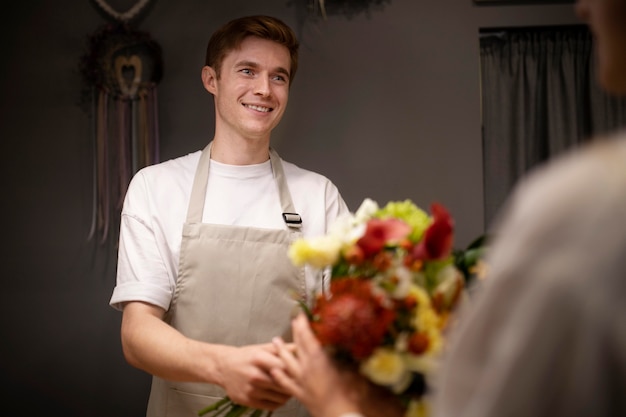 Male florist holding a beautiful bouquet