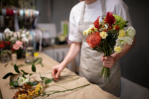 Male florist making a beautiful bouquet