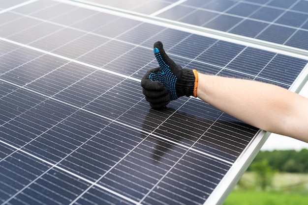 Male hand cleaning solar panels with towel to wipe dirty Solar power for green energy