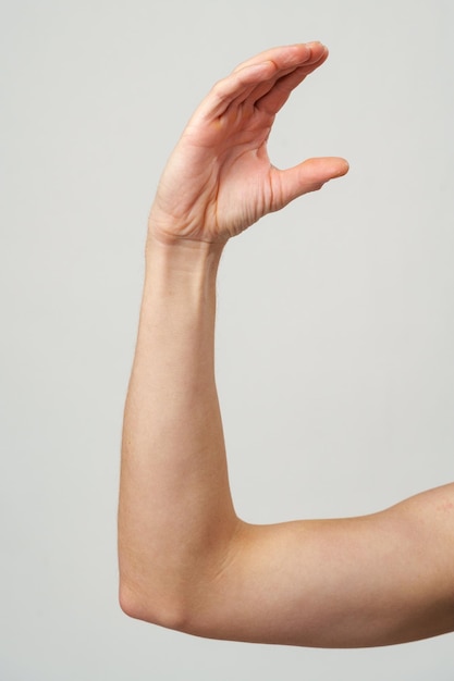 Male hand gestures over gray background studio shot