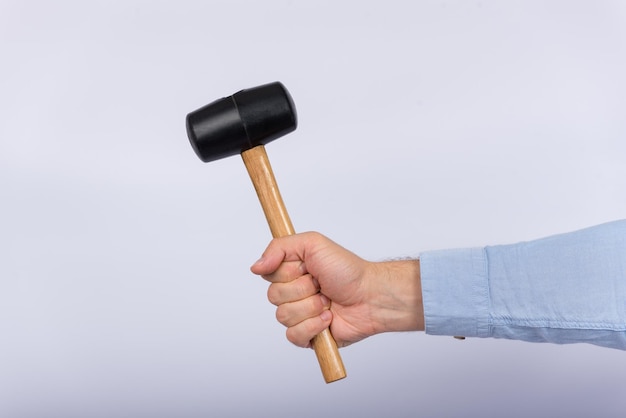 Male hand holding hammer on white background Side view