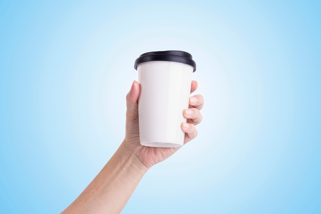 Male hand holding a white coffee cup isolated 