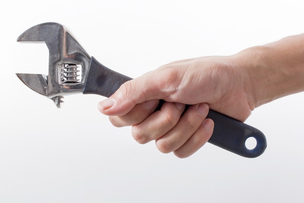 male hand holding wrench on white background