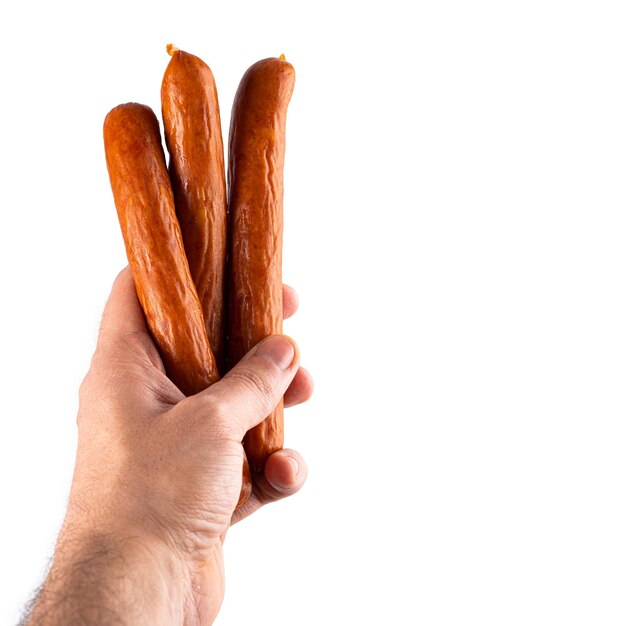 Male hand holds frankfurter sausage Isolated on white background