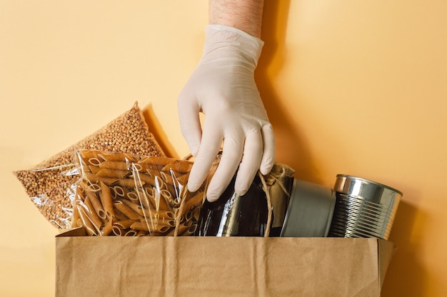 Male hand and Paper bag with Food supplies crisis for quarantine