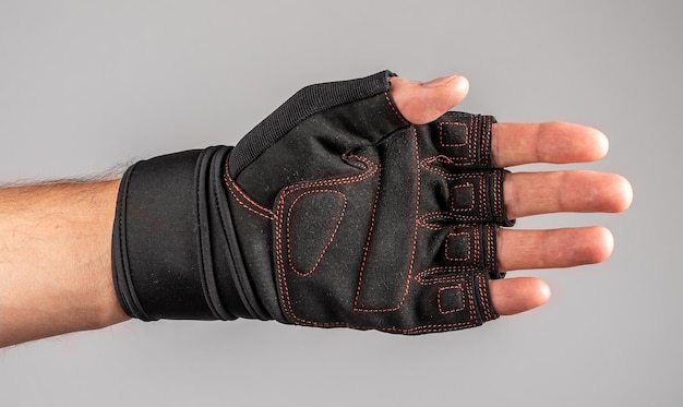 Male hand in sport glove for gym workout training protection for palm and fingers