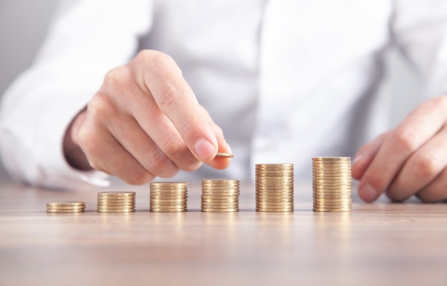 Male hand stacking coins. Saving money. Business. Investment