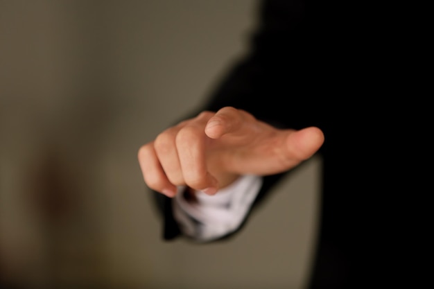 Male hand with finger pointing on blurred background