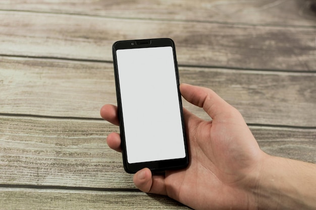 Male hand with smart phone with white screen