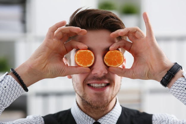 Male hands hold a cut fruit at eye level