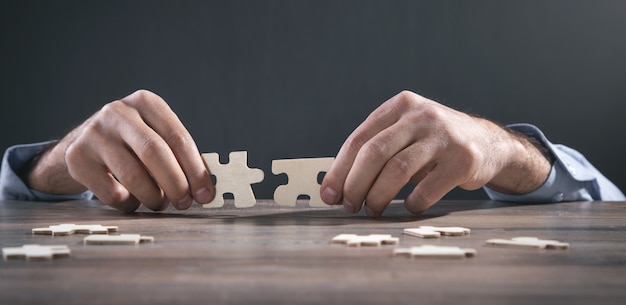 Male hands holding a jigsaw puzzle.