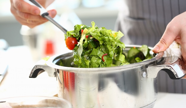 Male Hands Mixing Organic Chopped Vegetable Salad