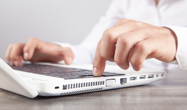 Male hands typing on computer keyboard.