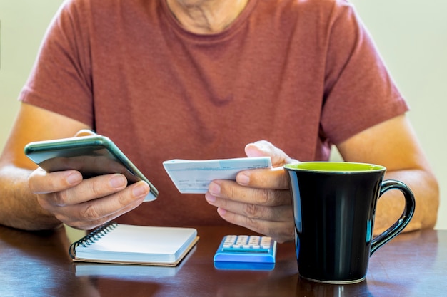 Male hands using calculator apps at desk